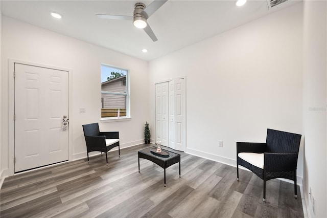 sitting room featuring ceiling fan and hardwood / wood-style floors