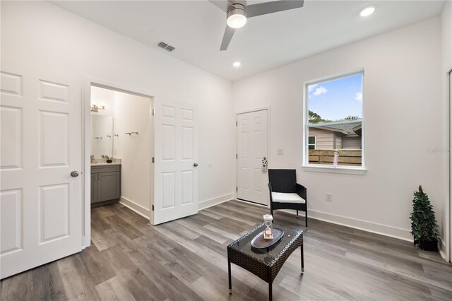 living area with ceiling fan and hardwood / wood-style flooring