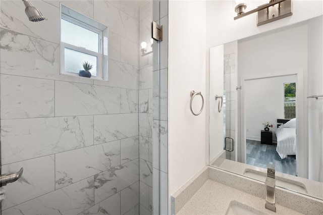 bathroom featuring walk in shower and vanity