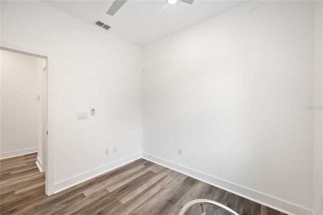 spare room with ceiling fan and dark hardwood / wood-style floors