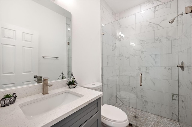 bathroom with vanity, toilet, and a shower with door