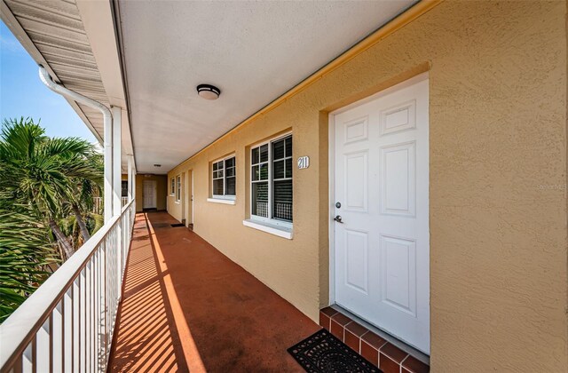 view of exterior entry featuring a balcony