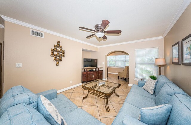 tiled living room featuring ceiling fan and crown molding