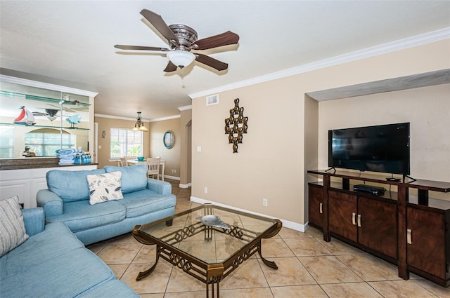 living room with light tile patterned floors, ornamental molding, and ceiling fan