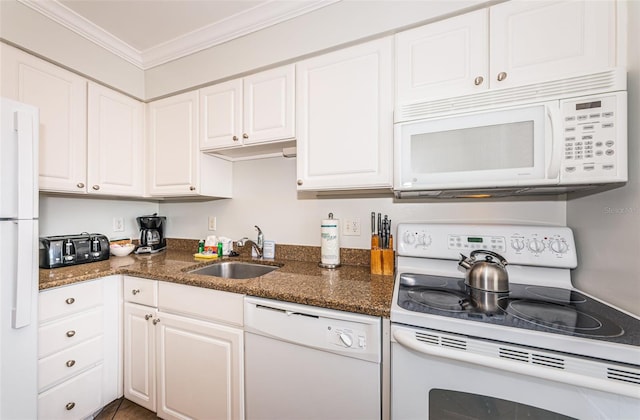 kitchen featuring white cabinets, sink, and white appliances