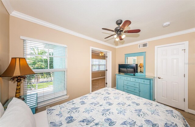 bedroom with crown molding, tile patterned flooring, and ceiling fan