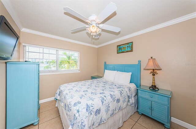 bedroom with crown molding, light tile patterned floors, and ceiling fan