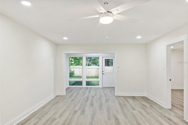 unfurnished room featuring light hardwood / wood-style flooring and ceiling fan