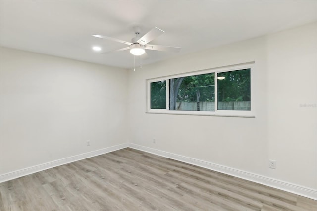 empty room with light hardwood / wood-style floors and ceiling fan