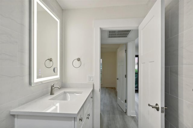 bathroom with vanity and hardwood / wood-style flooring