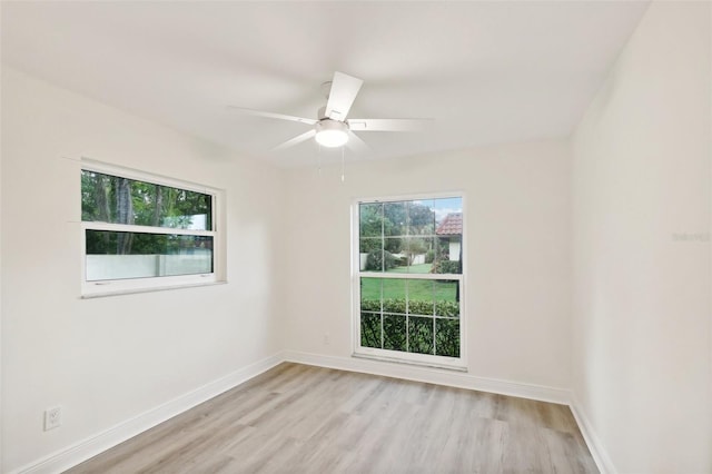 spare room with light hardwood / wood-style flooring and ceiling fan