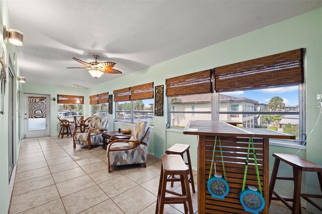 sunroom featuring ceiling fan