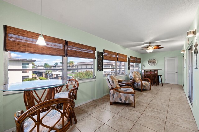 sunroom featuring ceiling fan