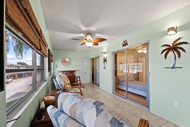 sunroom / solarium featuring ceiling fan