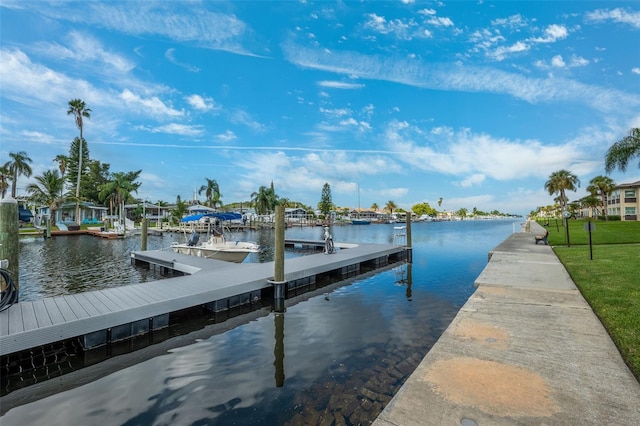 dock area featuring a lawn and a water view