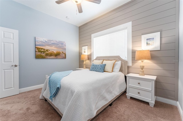 carpeted bedroom with wood walls and ceiling fan