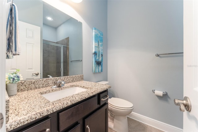 bathroom with tile patterned floors, walk in shower, vanity, and toilet