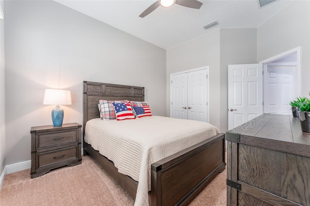 carpeted bedroom featuring a closet, vaulted ceiling, and ceiling fan