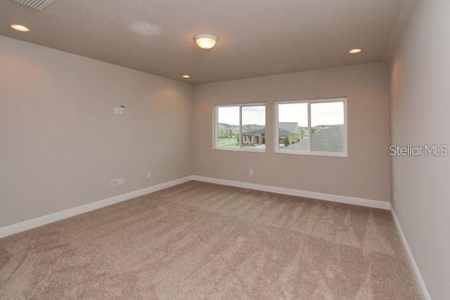 empty room featuring light colored carpet