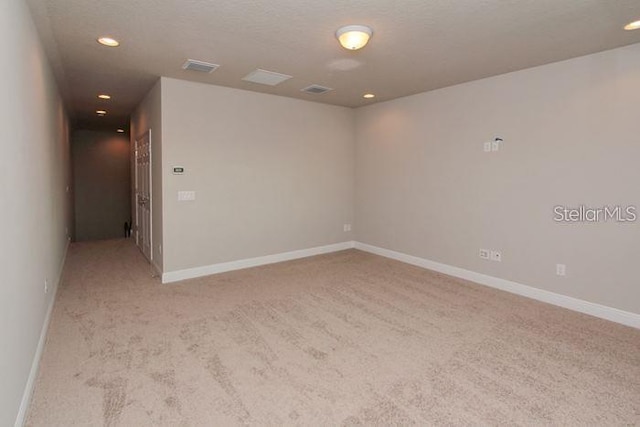 spare room with light colored carpet