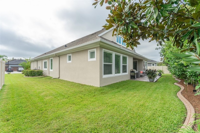 rear view of property with a patio and a yard