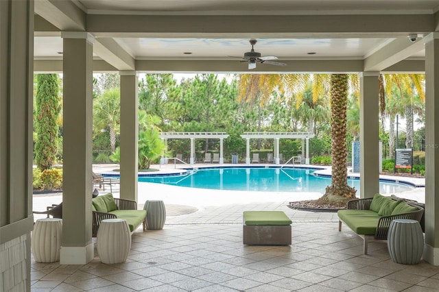 view of pool with ceiling fan, a pergola, and a patio