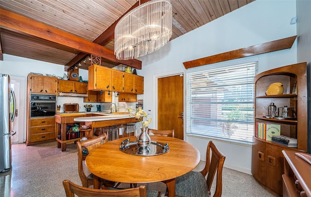 dining space with wooden ceiling, vaulted ceiling with beams, sink, and a chandelier