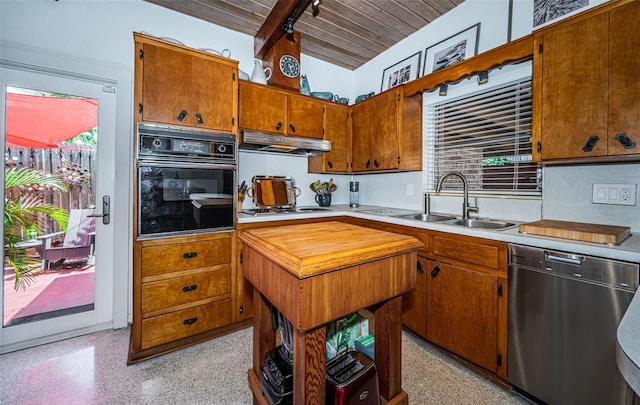 kitchen with appliances with stainless steel finishes, vaulted ceiling with beams, wood ceiling, and sink