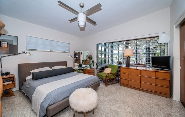 bedroom featuring ceiling fan, light colored carpet, and lofted ceiling