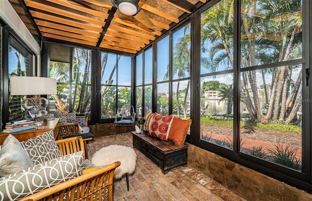 sunroom / solarium with a water view