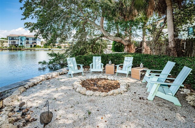 exterior space with a fire pit and a water view