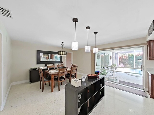 kitchen with light stone countertops and decorative light fixtures