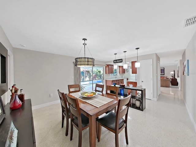 dining space with a chandelier