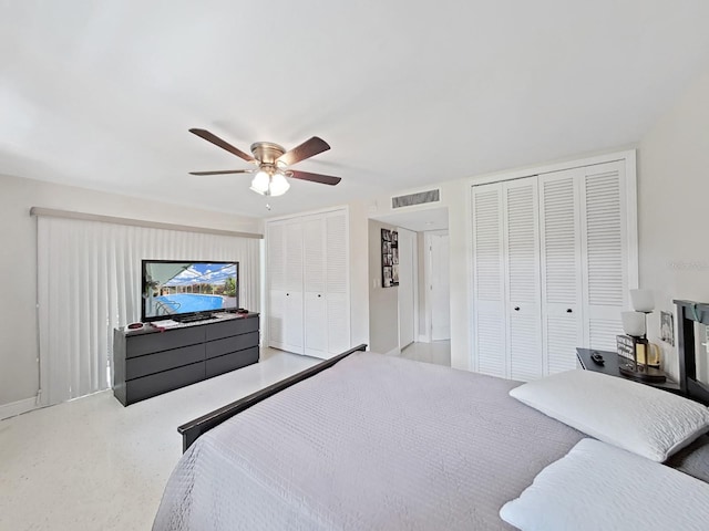 bedroom with ceiling fan and multiple closets