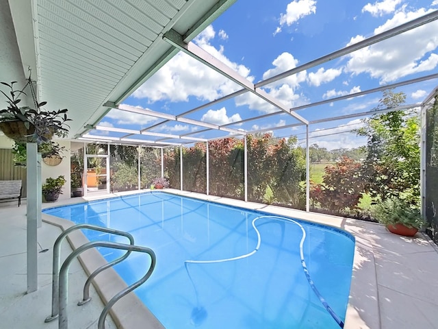 view of swimming pool with a patio and a lanai