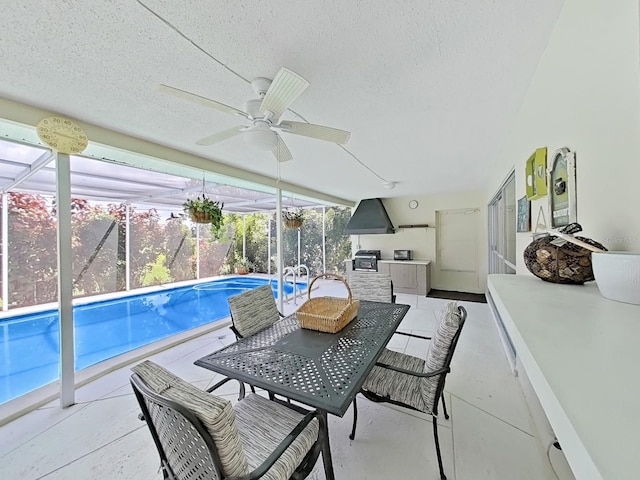 exterior space with a patio, glass enclosure, and ceiling fan