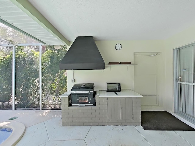 exterior space with a textured ceiling and extractor fan