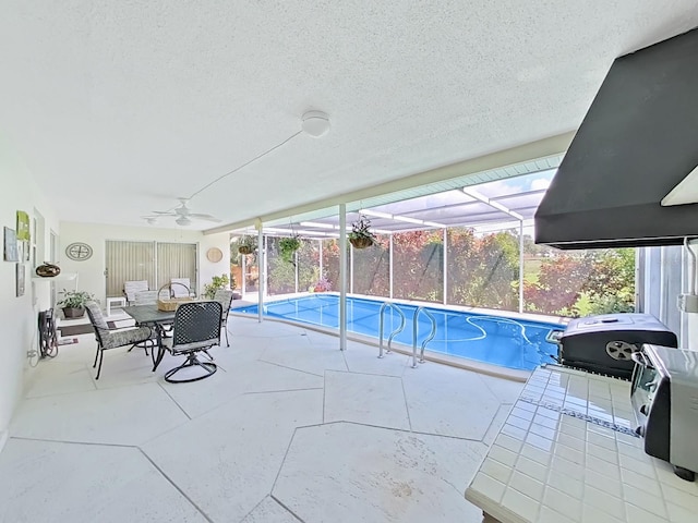 view of swimming pool featuring a patio, a lanai, and a grill