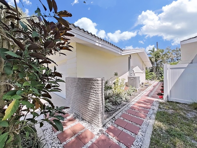 view of property exterior with central AC