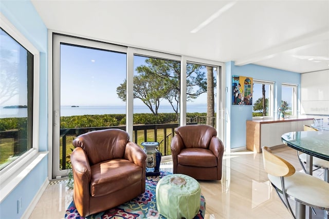 sunroom / solarium featuring a water view and a wealth of natural light