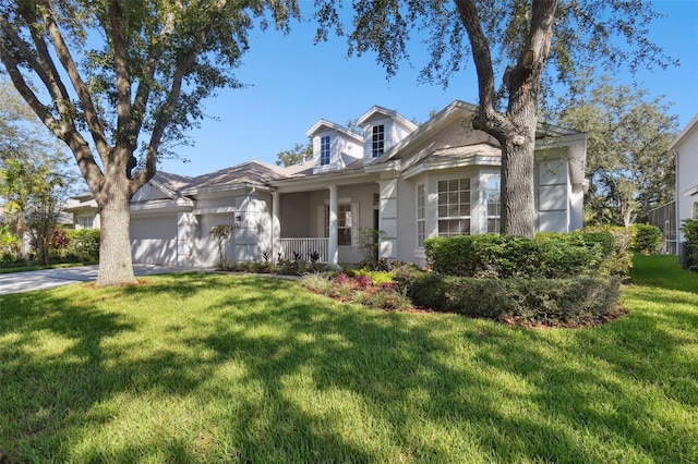 view of front of home with a garage and a front lawn