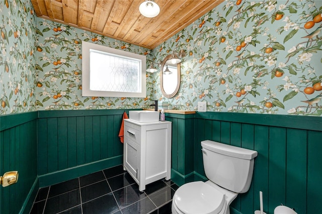 bathroom featuring tile patterned flooring, wooden ceiling, vanity, and toilet