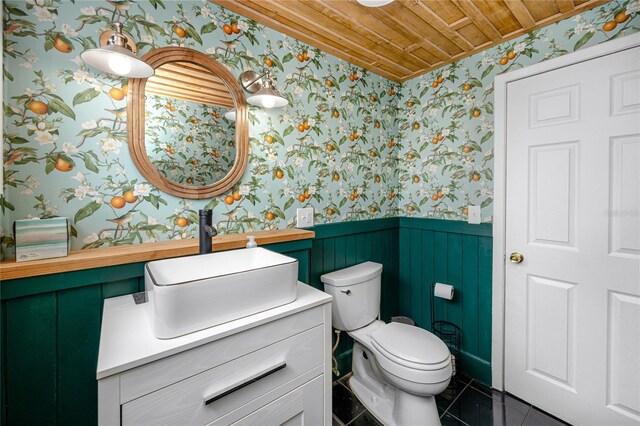 bathroom featuring tile patterned floors, wooden ceiling, vanity, and toilet