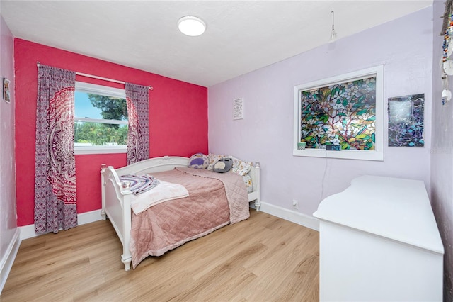 bedroom with hardwood / wood-style floors