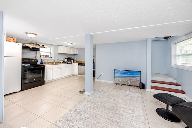 kitchen with white cabinets, white fridge, black range with electric cooktop, stainless steel dishwasher, and sink