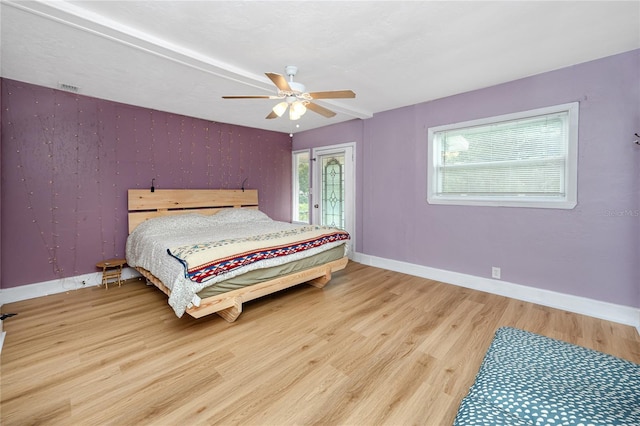 bedroom with light hardwood / wood-style floors and ceiling fan