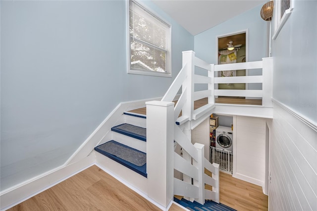 stairs featuring vaulted ceiling and hardwood / wood-style floors