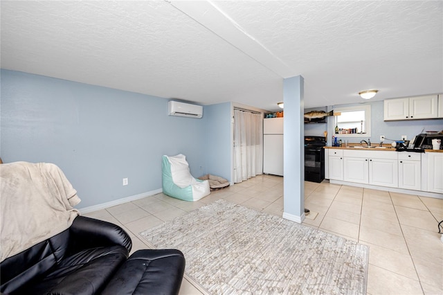 interior space with sink, a wall mounted air conditioner, and a textured ceiling