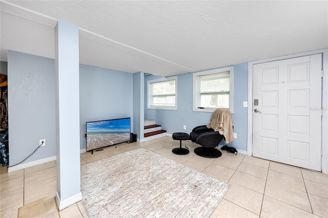 sitting room with a textured ceiling and light tile patterned floors