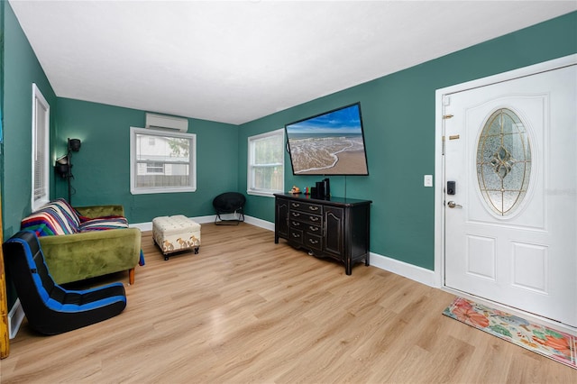 foyer featuring an AC wall unit and light wood-type flooring